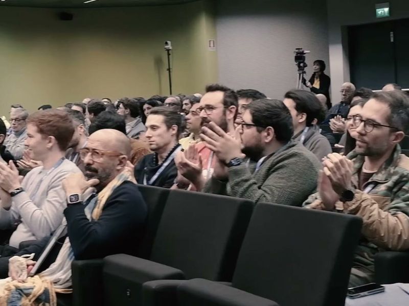 Audience applauding a talk at AI Heroes